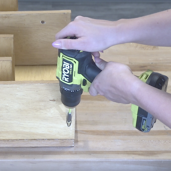 Screwing shelf into the wine rack base